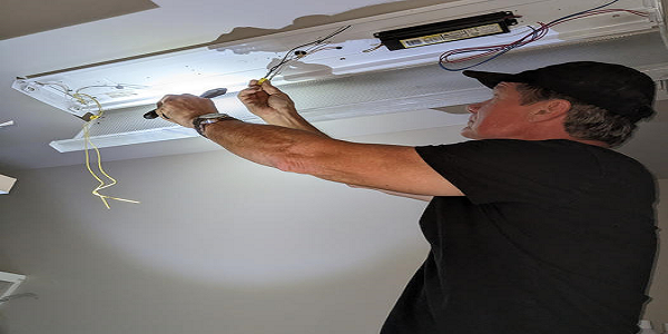 Handyman Repairing Light Fixture